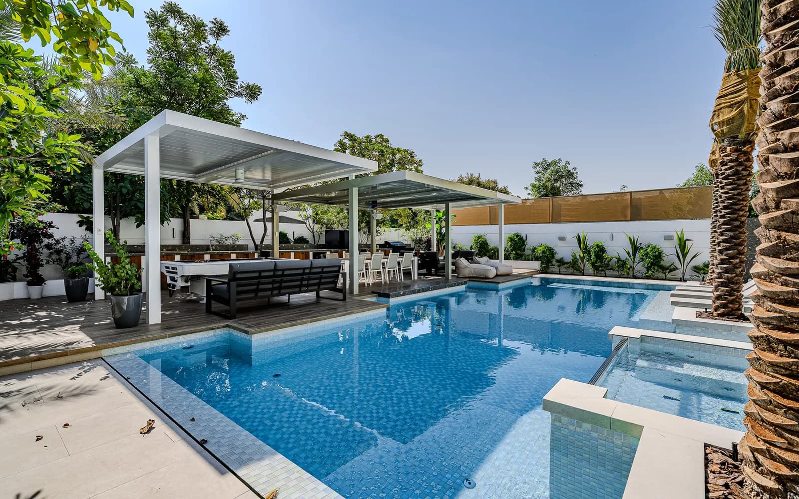 Swimming pool and pergola in a renovated villa garden